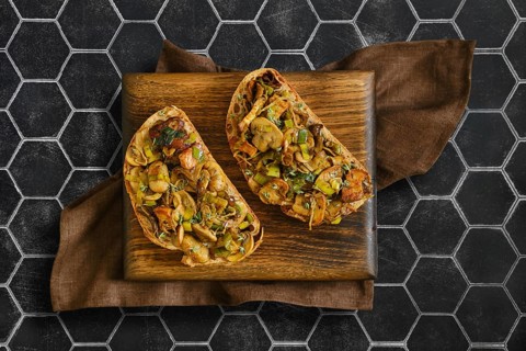 Two sandwiches with flavorful mix of honey mushrooms, enoki mushrooms, champignon, and leeks.