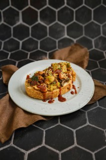 A mouthwatering mushroom sandwich topped with honey mushrooms, enoki mushrooms, and champignon