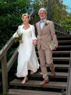 Elderly couple's wedding on wooden bridge