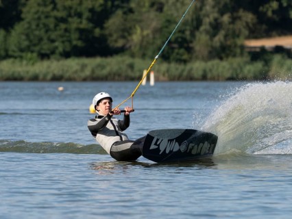 Young man with wakeboard, sporty on water, athletic model, active water sports, wake park