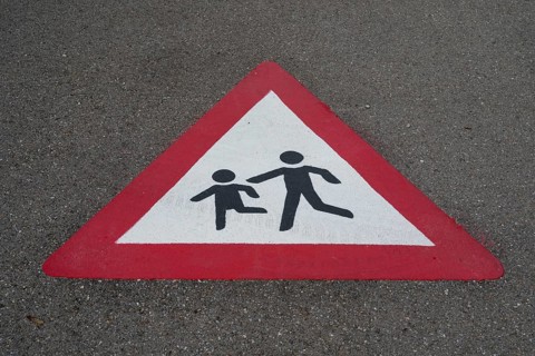 Traffic sign, children playing, road with marking on the asphalt, Bavaria, Germany
