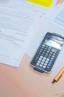 A calculator is lying on a table with mathematical documents, Jugend Forschungszentrum Nagold, Calw