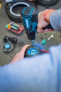 Person using a drill to assemble in a workshop environment, Jugend Forschungszentrum Nagold,