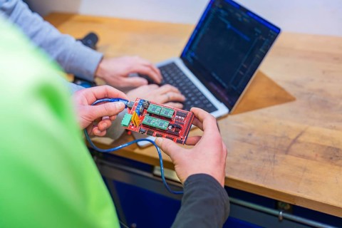 Circuit board is held while someone is working on a laptop, Jugend Forschungszentrum Nagold, Calw