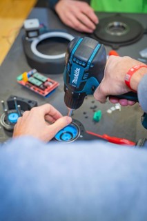 Person uses drills to secure components to a table, Jugend Forschungszentrum Nagold, Calw district,