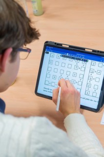 Person taking handwritten notes on a tablet, Jugend Forschungszentrum Nagold, Calw district,