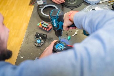 A person uses a drill in a workshop, Jugend Forschungszentrum Nagold, Calw district, Germany