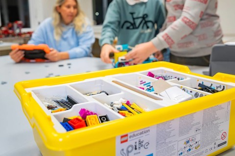 Children playing with a yellow Lego set on a table, Jugend Forschungszentrum Nagold, Calw district,