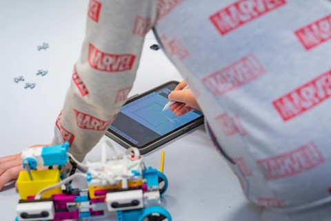 Child uses a tablet to control or design a robot, Jugend Forschungszentrum Nagold, Calw district,