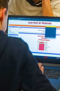 Young person looking at math problems on a laptop screen, Jugend Forschungszentrum Nagold, Calw
