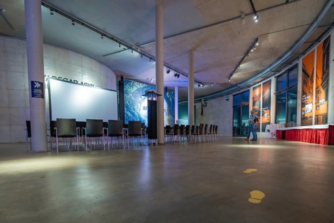 A modern gallery space with chairs and atmospheric lighting, Amazonia exhibition, Gasometer,