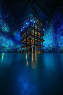 Tall structure with fascinating light installation in a blue room, Amazonia exhibition, Gasometer,