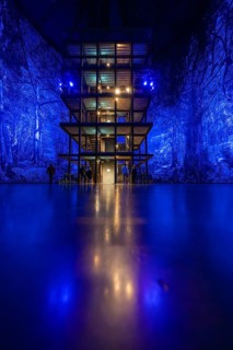 Illuminated structure in front of an intense blue forest projection in an interior, Amazonia