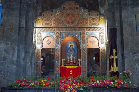 A richly decorated altar in a church surrounded by flowers and icons, Sevanavank Monastery,