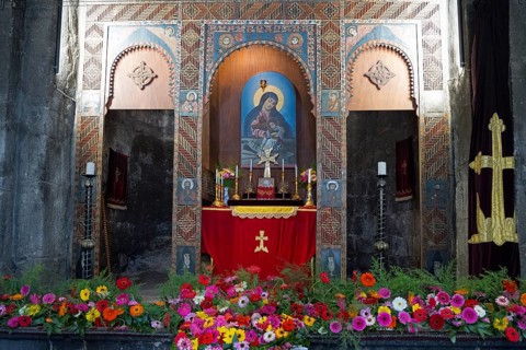 Magnificent altar in a church decorated with colorful flowers and religious paintings, Sevanavank