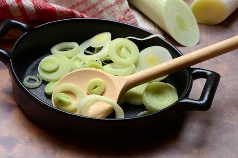 Leeks, leek rings in pan with cooking spoon, leek