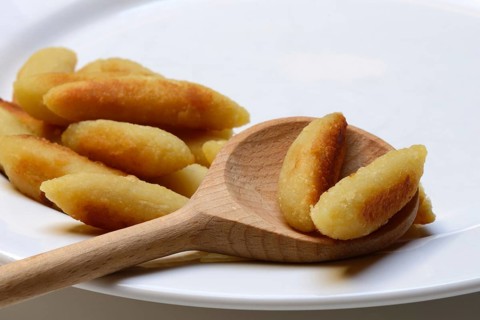 Fried puff noodles with cooking spoon on plate