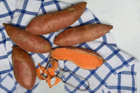 Sweet potatoes with potato peeler, Ipomoea batatas