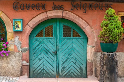 Antique wooden gate of a restaurant in Ellsass, France