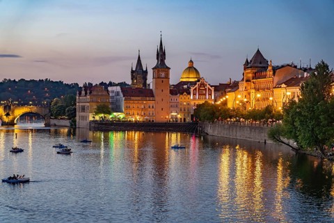 Vltava embankment with Old Town Water Tower, NovotnÃ½ Bridge and Charles Bridge at dusk, Prague,