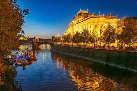 Vltava embankment with the Academy of Arts, Architecture and Design at dusk, Prague, Czech Republic