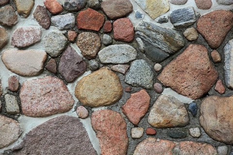 Wall made of stones in various shapes and pastel colors