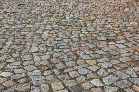 Rough cobblestone road with irregular arrangement of stones