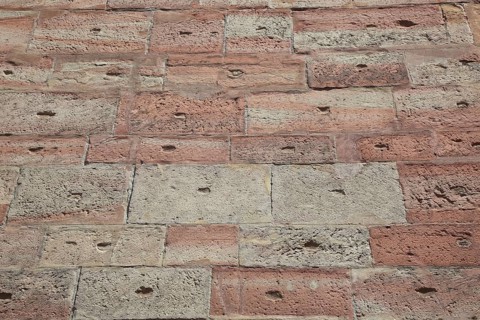 Textured brick wall in shades of red and brown with retro style