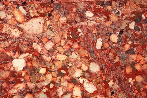 Marble surface in shades of red with diverse patterns and intensive color changes