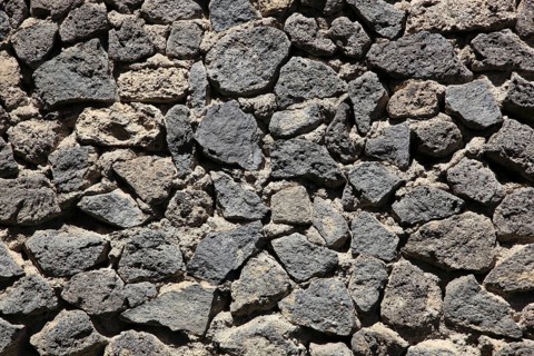Dense arrangement of gray lava stones in natural formation