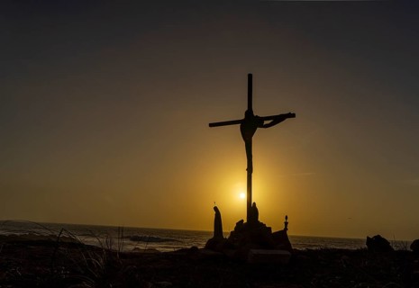 Religious scene, temporary Christian cross on the coast Farol de Cabo Raso lighthouse, SÃ£o Bras de