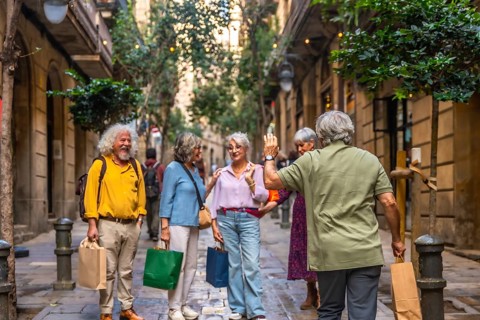 Group of diverse senior friends meeting and greeting on a charming narrow urban street, enjoying a