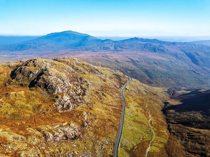 Autumn colours of Pen-y-Pass over Miner's Track, Start Point and road A4086 from a drone,