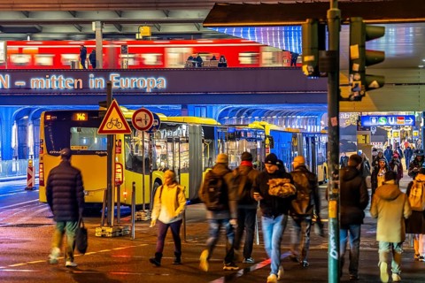 The main train station in Essen, blue illuminated underpass, bus station, am Europaplatz, train on