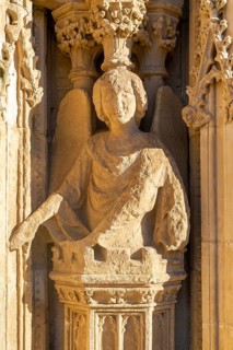 Carved stone figure of winged angel on West Front of Exeter cathedral church, Exeter, Devon,