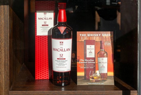 Bottle of Macallan whisky window display The Whisky Shop store, Cathedral Close, Exeter city