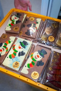 Various chocolate bars with painted snowmen in decorative packaging, Christmas baking, Haselstaller