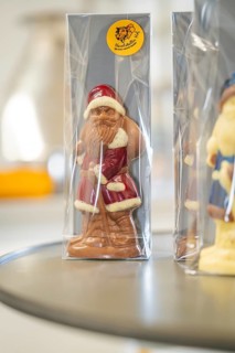 Chocolate Santa figure in red coat wrapped in transparent packaging, Christmas baking, Haselstaller