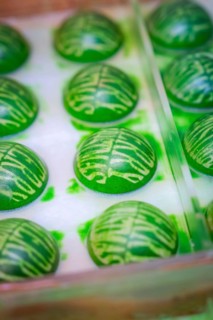 Green shaped chocolate balls with decorative pattern in a mold, Christmas baking, Haselstaller Hof,
