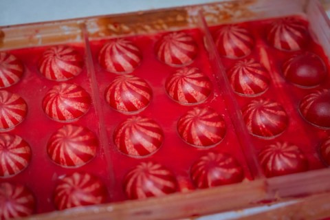 Red chocolate candy with white stripes in a chocolate mold, Christmas baking, Haselstaller Hof,