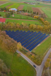 Solar systems embedded in fields and trees shown from the air during autumn, Bau PV