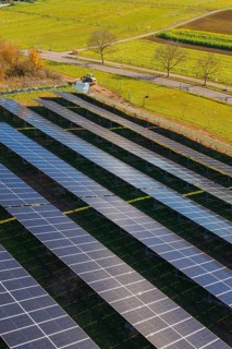 Close-up of solar panels in a field surrounded by autumn leaves, Bau PV Freifaechenanlage, Weil der