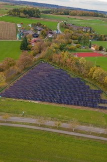 Extensive rural views with solar panels next to a small village, construction of a PV open-air