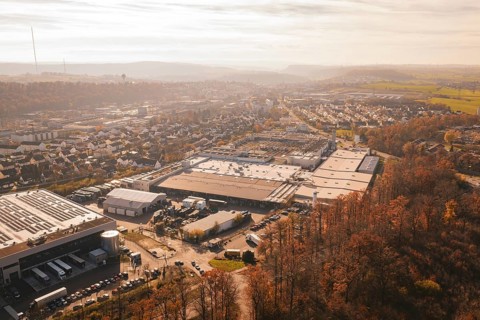 Industrial complex and urban settlements surrounded by autumn vegetation, MÃ¼hlacker, Enzkreis,