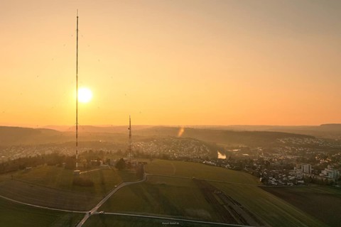 An idyllic sunset over vast fields with a dominant transmission tower, MÃ¼hlacker, Enzkreis,