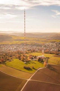 The transmission tower towers over a vast landscape with fields and villages, MÃ¼hlacker, Enzkreis,