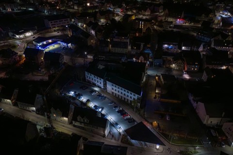 Nighttime view of city roads with parked cars and illuminated buildings, Nagold, Calw district,