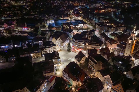 Night view of a city with illuminated streets, many buildings and a church, Nagold, Calw district,