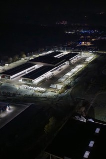 Night view of an industrial area with illuminated buildings and trucks, Nagold, Calw district,
