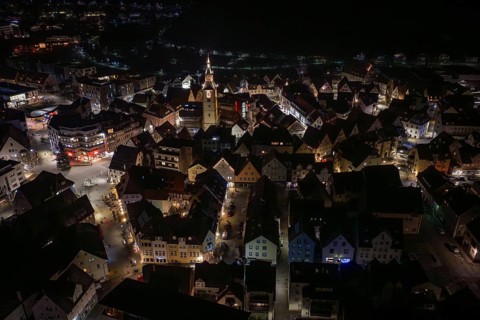 Night panorama of a city with a centrally located, illuminated church tower, Nagold, Calw district,